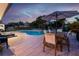 Inviting backyard pool area with lounge chairs and patio dining under an umbrella at 13168 84Th Ter, Seminole, FL 33776