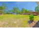Beautiful backyard with manicured lawn, modern fence, outdoor structure, and Adirondack chairs at 15207 Taralane Ave, Brooksville, FL 34604