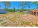 Large, fenced backyard with mature trees and several outbuildings at 15207 Taralane Ave, Brooksville, FL 34604