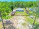 Drone image of fenced backyard featuring a cozy hot tub and an open pergola-covered space at 15207 Taralane Ave, Brooksville, FL 34604
