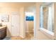 This bathroom features granite countertops and a view into an adjoining tiled shower at 15207 Taralane Ave, Brooksville, FL 34604