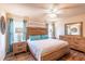Comfortable bedroom featuring light-colored walls, wood floors, and a light ceiling fan at 15207 Taralane Ave, Brooksville, FL 34604