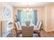 Cozy dining area with stylish light fixture, large window with view of backyard and comfortable seating at 15207 Taralane Ave, Brooksville, FL 34604