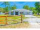 Charming one-story home with a fenced yard and lush green grass at 15207 Taralane Ave, Brooksville, FL 34604