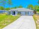 Inviting single story home with a manicured lawn, complementary shrubs and a long driveway at 15207 Taralane Ave, Brooksville, FL 34604