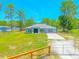 Single story home features a well-kept lawn and concrete driveway, surrounded by mature trees at 15207 Taralane Ave, Brooksville, FL 34604