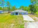 Charming home boasts a well-manicured lawn and a lengthy concrete driveway at 15207 Taralane Ave, Brooksville, FL 34604