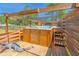 Outdoor hot tub offers a luxurious spa-like experience, with a wood surround and privacy fencing at 15207 Taralane Ave, Brooksville, FL 34604
