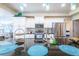 Bright and airy kitchen featuring white cabinets, stainless steel appliances, a large island, and ample counter space at 15207 Taralane Ave, Brooksville, FL 34604