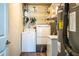 Laundry room featuring white washer and dryer, shelving, and water heater at 15207 Taralane Ave, Brooksville, FL 34604