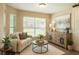 Cozy living room featuring a large window and natural decor at 15207 Taralane Ave, Brooksville, FL 34604
