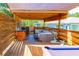 A covered outdoor space features a built-in kitchen, comfortable seating and a pool table for entertaining at 15207 Taralane Ave, Brooksville, FL 34604