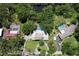 Birds eye view of property featuring pools, tennis court and mature landscaping at 1670 Fox Rd, Clearwater, FL 33764