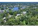 Aerial view of a neighborhood featuring beautiful homes, lush foliage and a lake at 1670 Fox Rd, Clearwater, FL 33764
