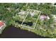 Aerial view of the home's large lot that backs up to a pond, with large, mature trees at 1670 Fox Rd, Clearwater, FL 33764