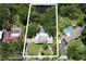 Aerial shot of the home displaying the pool, well manicured grounds and circular driveway with mature trees at 1670 Fox Rd, Clearwater, FL 33764