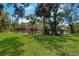Lush backyard with pond and beautiful green grass at 1670 Fox Rd, Clearwater, FL 33764