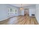 Bright dining room with wood floors, stylish chandelier and bay window with shutters at 1670 Fox Rd, Clearwater, FL 33764