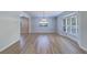 Inviting dining room with wood floors, stylish lighting and window with shutters at 1670 Fox Rd, Clearwater, FL 33764