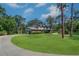 Exterior view of home with lush landscaping and long driveway at 1670 Fox Rd, Clearwater, FL 33764