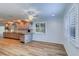 Bright eat-in kitchen with wood floors, breakfast bar and stainless appliances at 1670 Fox Rd, Clearwater, FL 33764