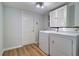 Practical laundry room with washer, dryer, cabinets and utility sink at 1670 Fox Rd, Clearwater, FL 33764