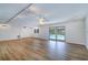 Expansive living room with wood floors, and sliding glass doors with a pool view at 1670 Fox Rd, Clearwater, FL 33764