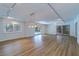 Large living room with wood floors, and sliding glass doors with a pool view at 1670 Fox Rd, Clearwater, FL 33764
