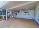 A covered outdoor patio with a ceiling fan and a TV for relaxing entertainment and enjoyment at 1670 Fox Rd, Clearwater, FL 33764