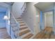 A staircase with wood and white railings, and lots of light with access to other rooms in the home at 1670 Fox Rd, Clearwater, FL 33764