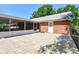 Fenced backyard featuring a brick patio, storage sheds, and a lush green lawn at 17801 Simmons Rd, Lutz, FL 33548