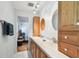 Bright bathroom featuring double sinks, wood cabinets, and tile flooring at 17801 Simmons Rd, Lutz, FL 33548