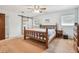 Bedroom features a sliding barn door, natural light, neutral walls and a wooden bed frame at 17801 Simmons Rd, Lutz, FL 33548