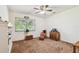 Bedroom with carpet, rocking chair and natural light from the bright window at 17801 Simmons Rd, Lutz, FL 33548