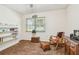 Cozy bedroom with rocking chair, soft carpet, and a sunny window at 17801 Simmons Rd, Lutz, FL 33548