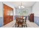 Cozy dining room featuring a wood table, matching chairs, and a classic chandelier at 17801 Simmons Rd, Lutz, FL 33548