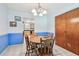 Blue dining room featuring a round wooden table and a doorway to the kitchen at 17801 Simmons Rd, Lutz, FL 33548
