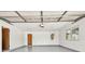 A clean, painted garage with a new epoxy floor, offering ample space for parking and storage at 17801 Simmons Rd, Lutz, FL 33548