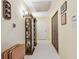 Inviting hallway featuring tile floors, a charming display cabinet, and classic decor at 17801 Simmons Rd, Lutz, FL 33548