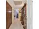 Open hallway with tile floors, wooden display cabinets, and a view to adjoining rooms at 17801 Simmons Rd, Lutz, FL 33548