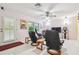 Comfortable living area with tile flooring, natural light, and leather chairs ideal for relaxing and entertaining at 17801 Simmons Rd, Lutz, FL 33548
