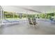 Expansive outdoor patio with screened-in porch, perfect for enjoying the serene backyard view at 17801 Simmons Rd, Lutz, FL 33548