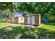 Outdoor sheds provide ample storage space in a well-maintained yard with mature trees at 17801 Simmons Rd, Lutz, FL 33548