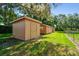 Outdoor shed with a painted exterior is in a well-maintained grassy yard at 17801 Simmons Rd, Lutz, FL 33548