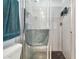 Shower room featuring a grey tiled surround and matte black shower floor at 17801 Simmons Rd, Lutz, FL 33548