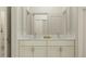 Bathroom featuring double vanity with white marble countertop and modern chrome faucets at 18477 Serene Lake Loop, Lutz, FL 33548