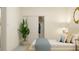 Calming bedroom features a large plant, closet and bed with neutral colored decorations at 18477 Serene Lake Loop, Lutz, FL 33548