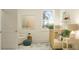 Well-lit Bedroom featuring a crib, neutral walls, and a white armchair at 18477 Serene Lake Loop, Lutz, FL 33548