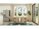 Bright dining room featuring modern lighting and an array of neutral tones at 18477 Serene Lake Loop, Lutz, FL 33548