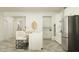 Stylish kitchen with stainless steel appliances, white cabinetry, and seating at the island counter offers a modern aesthetic at 18477 Serene Lake Loop, Lutz, FL 33548